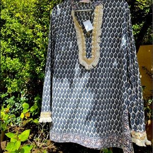 This is a beautiful made blue, tunic with triangular shells